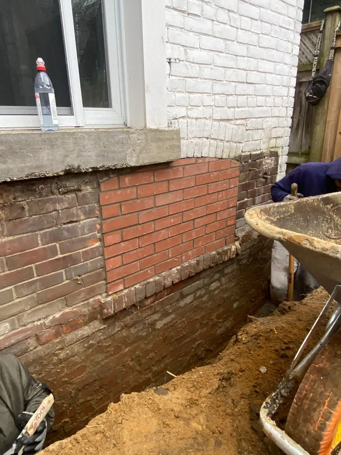 Excavated foundation wall during waterproofing work